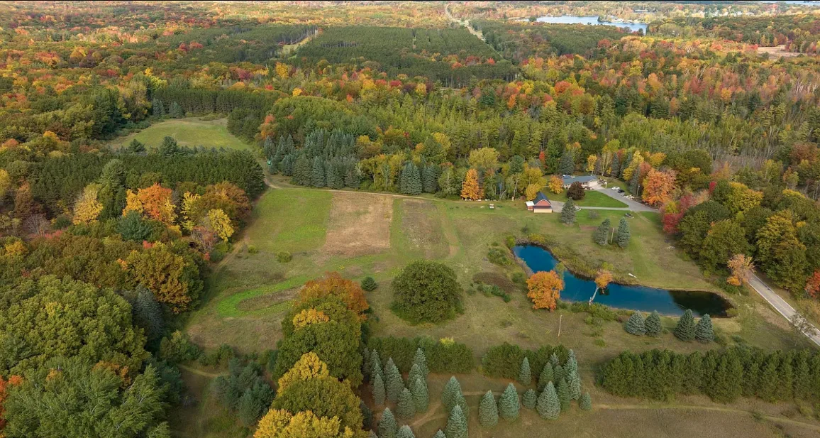 Aerial autumn view of the property's fields, ponds and surrounding woods
